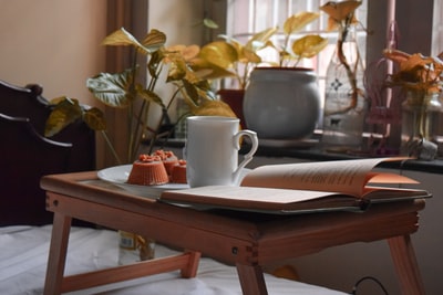 Brown wooden table in the white pages of white ceramic cup
